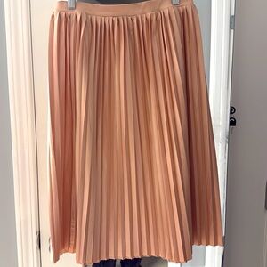 Cute blush pleaded skirt perfect for spring or summer. Pair with jean jacket.